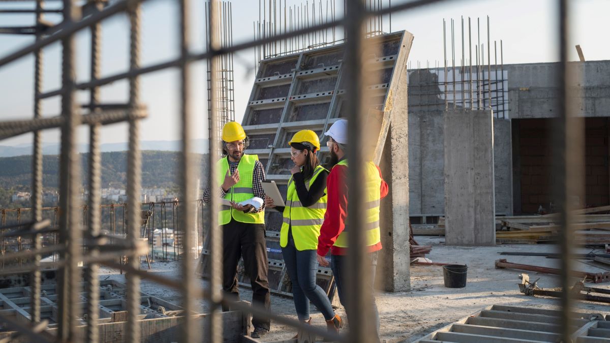 Three people on a construction site