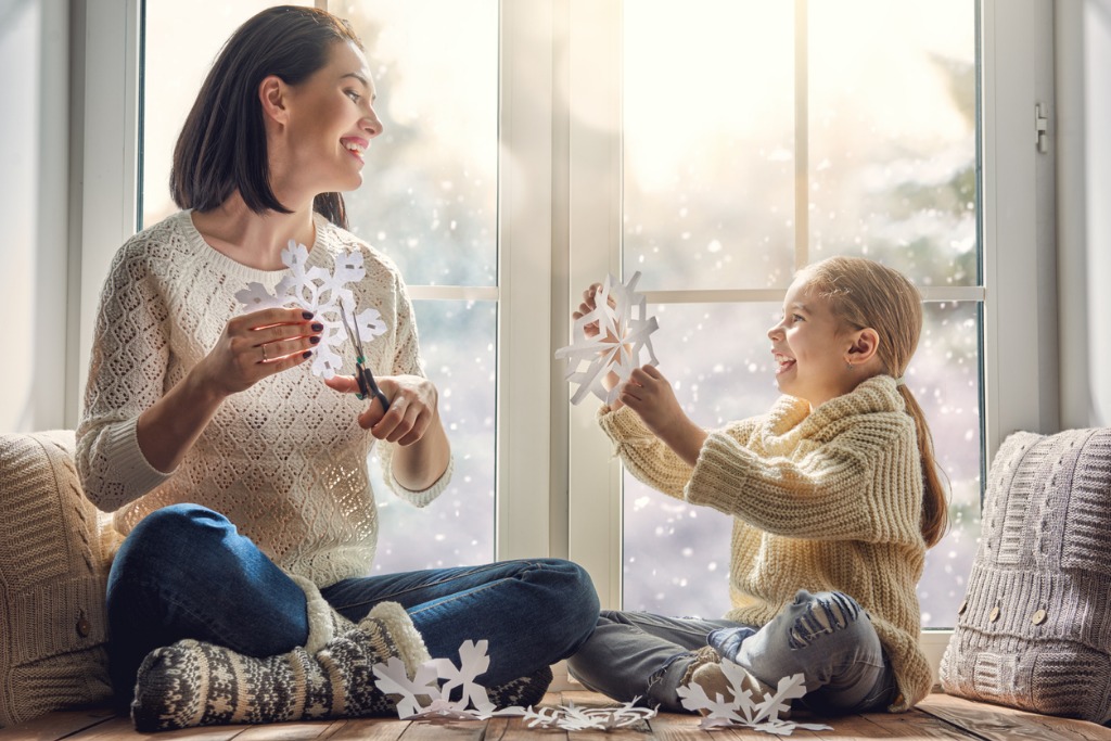 woman and child making snowflakes