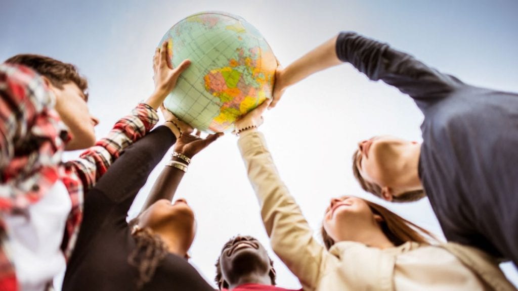 People holding on to a globe