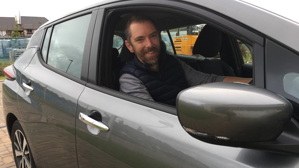 Matt Fraser sat in his electric car.