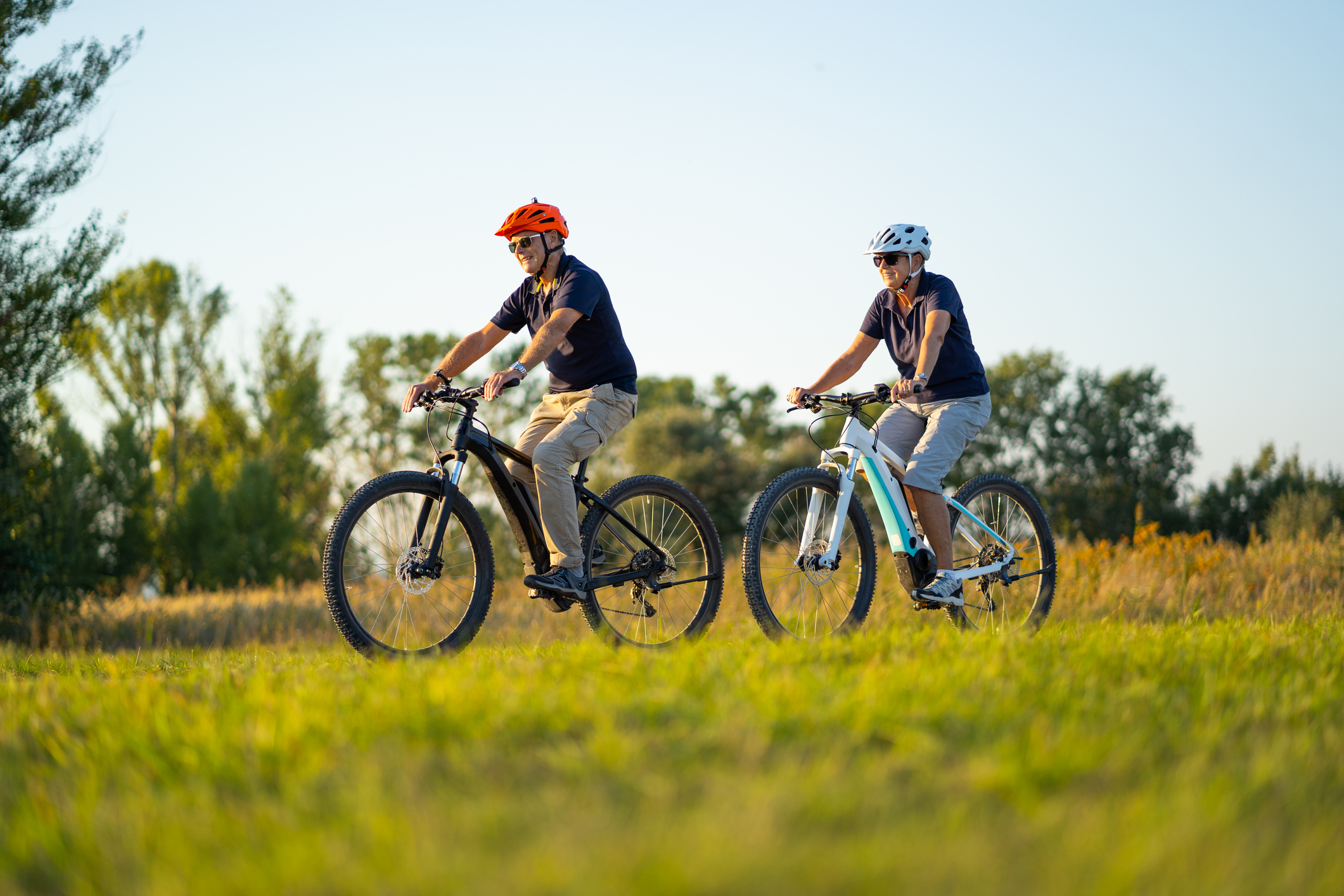 Two people cycling ebikes in the countryside