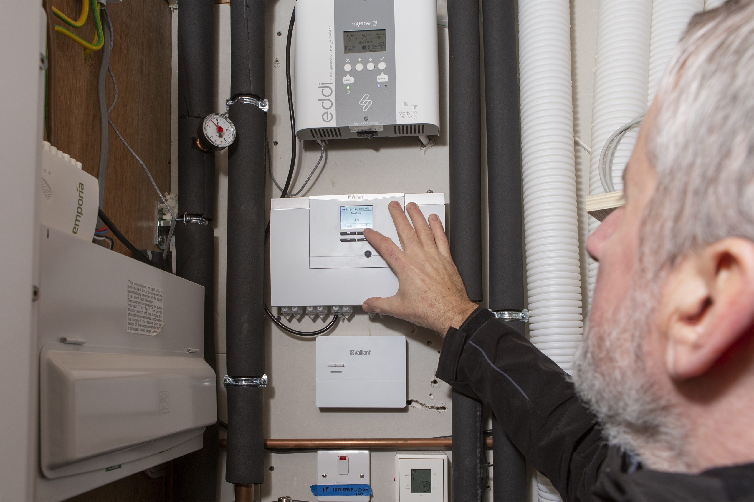 Installer looking at heating controls