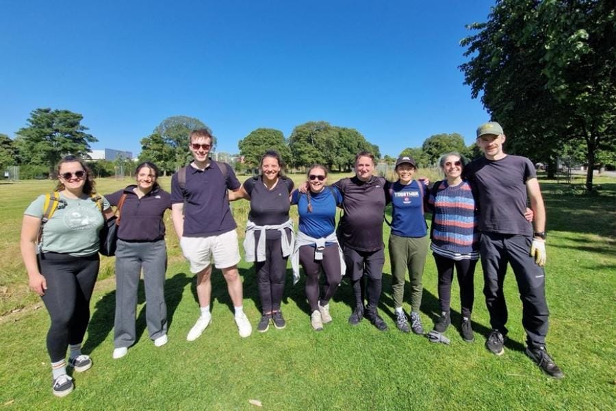 Energy Saving Trust and EY volunteers standing together at Leith Links