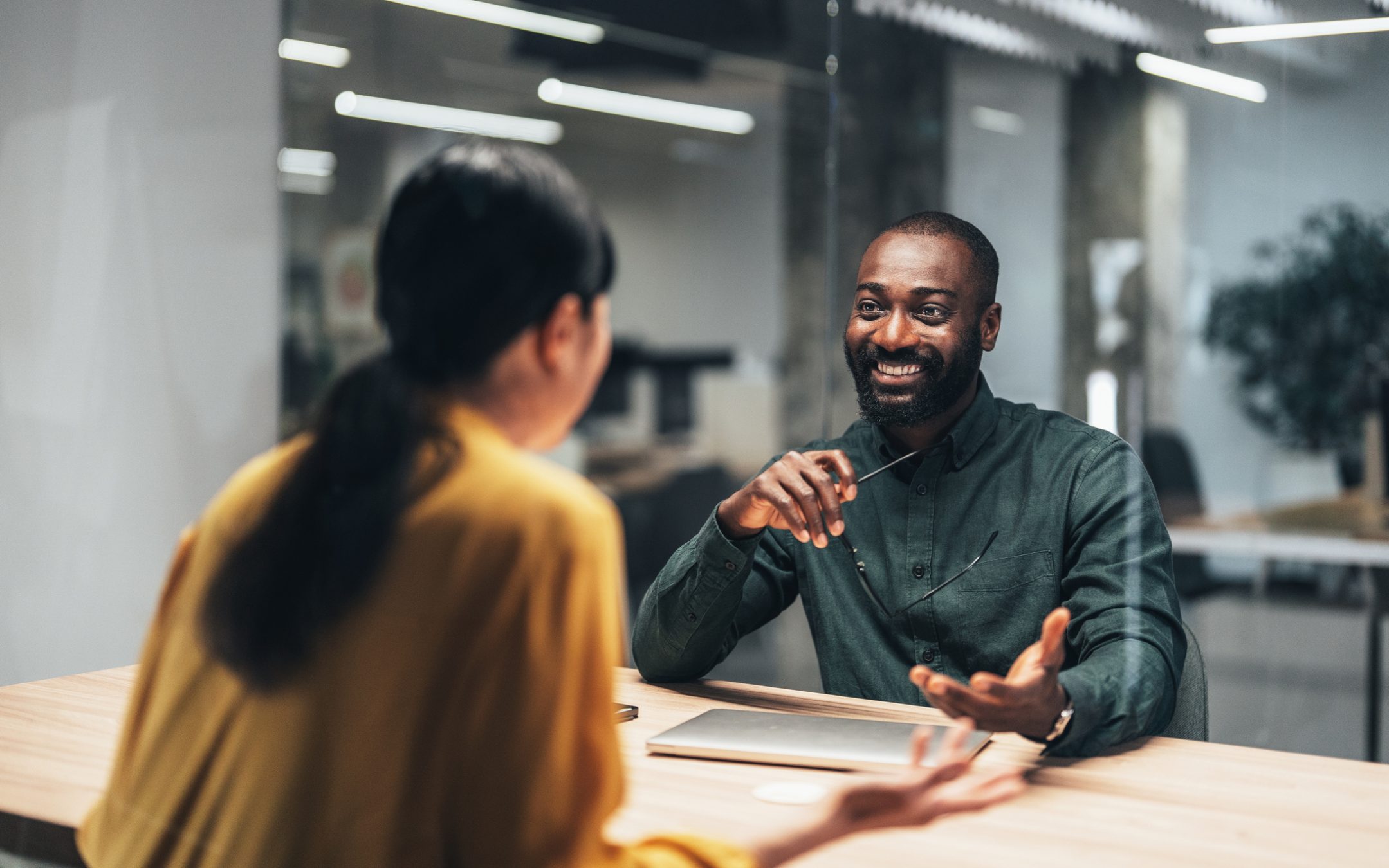 A buyer consults with a landing specialist in a sleek, modern building.